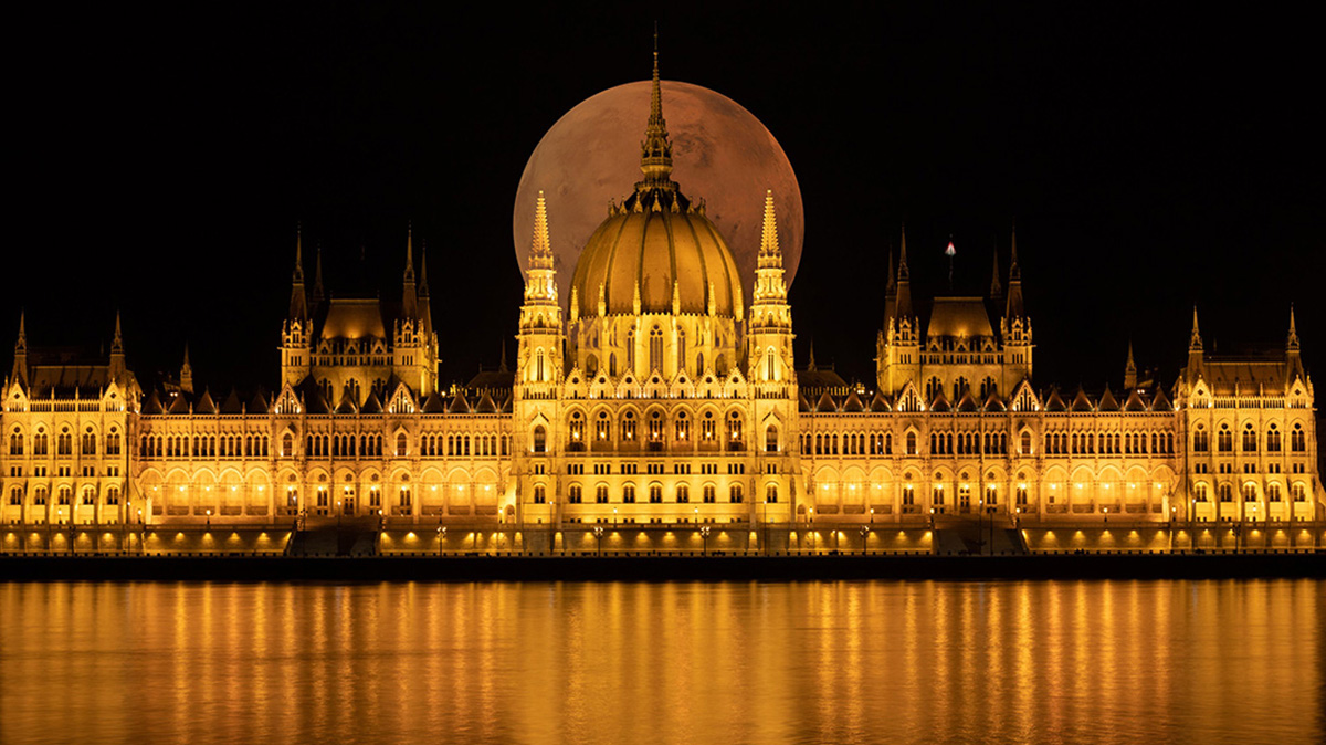 Hungarian Parliament Building seen at night with full moon